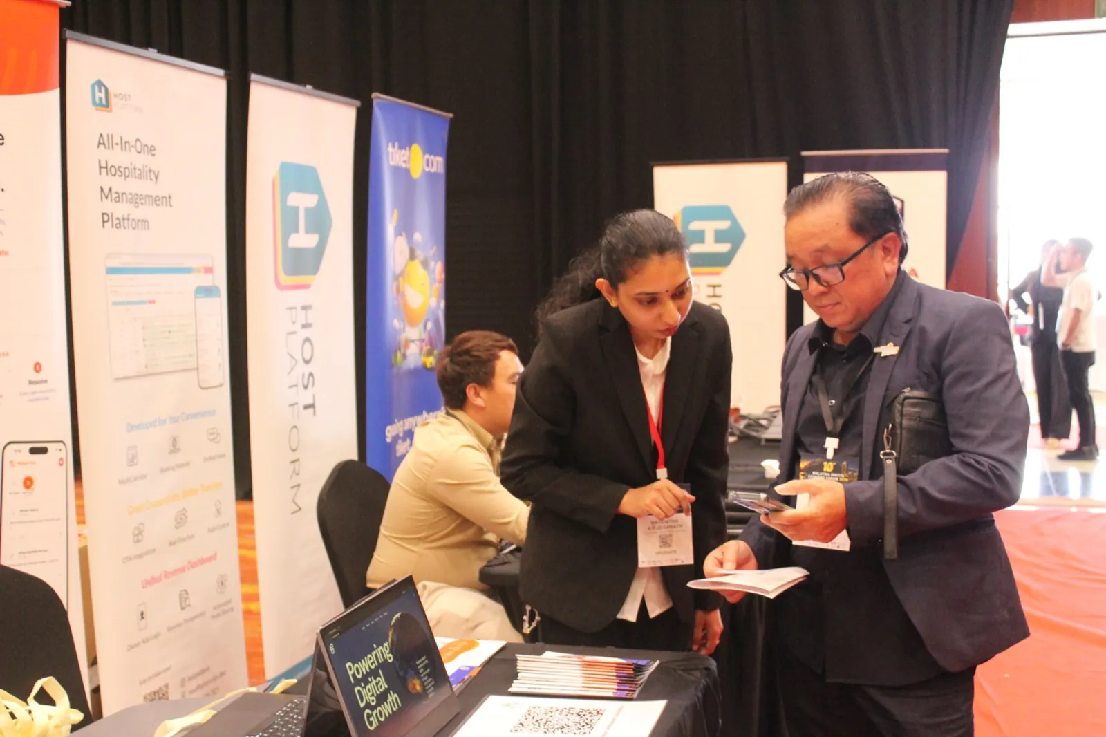 Product walkthrough for a visitor at the OC Global Technology booth during MDEF2026