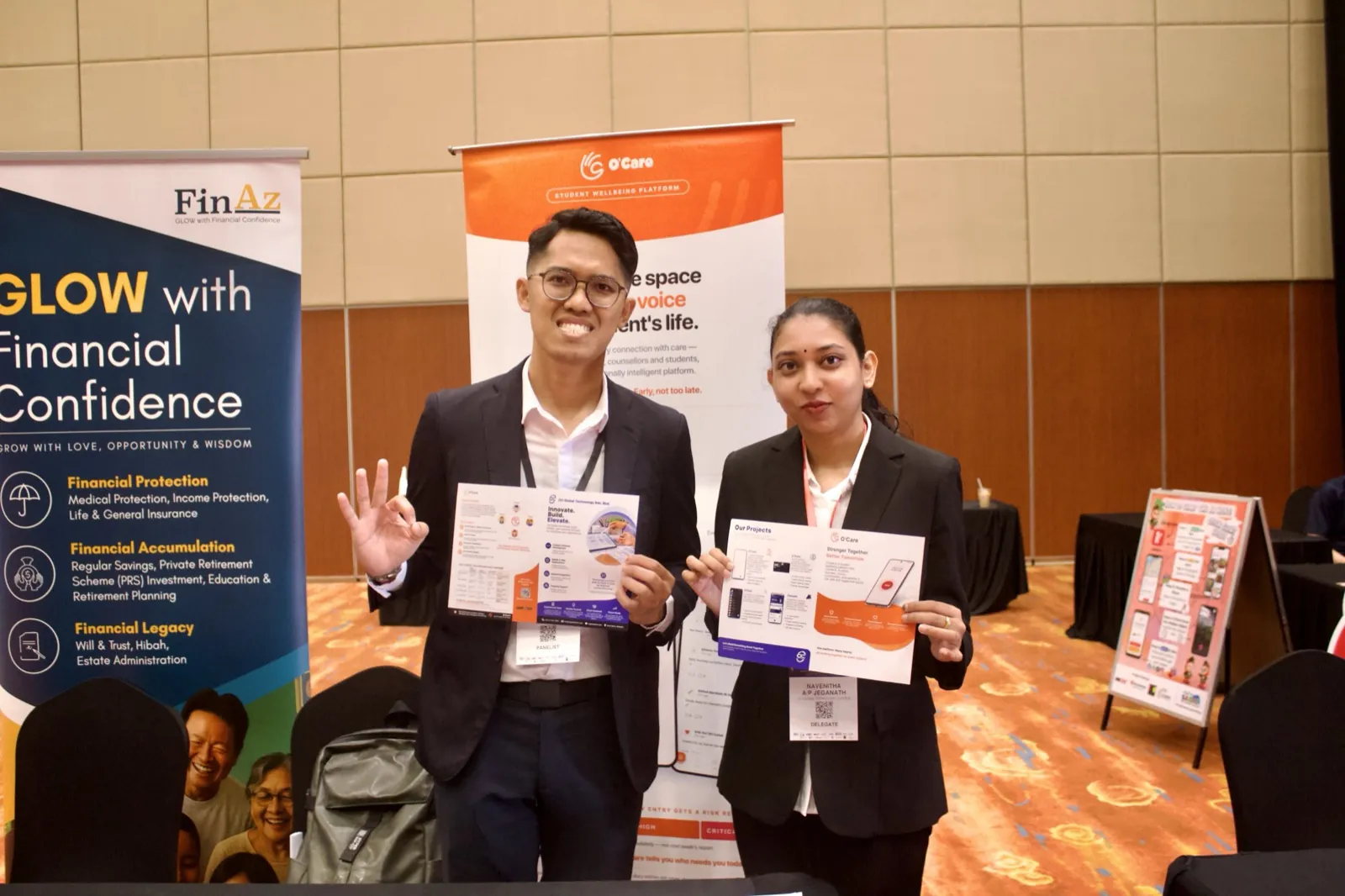 OC Global Technology team with product brochures at the booth